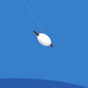 A roll of twine attached to a kite, released and gracefully soaring gently in the breeze